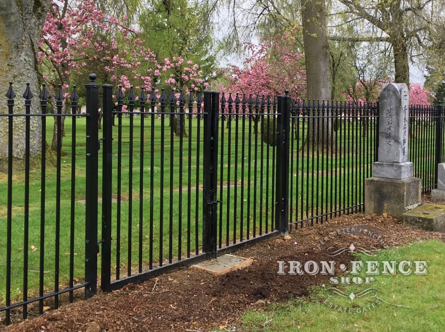 Wrought Iron Fence and Gate Surrounding a Cemetery 