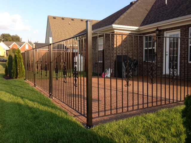 Iron Pool Style Fence with Guardian Decorations Around a Patio