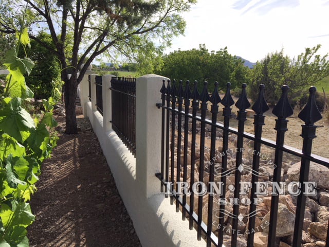 Our Classic style Stronghold Iron fence Mounted on top of a stucco knee wall