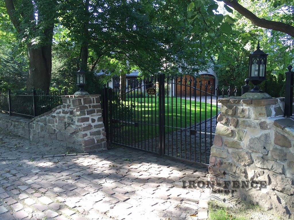 12ft Iron Driveway Gate Mounted on Posts  Behind Stone Columns