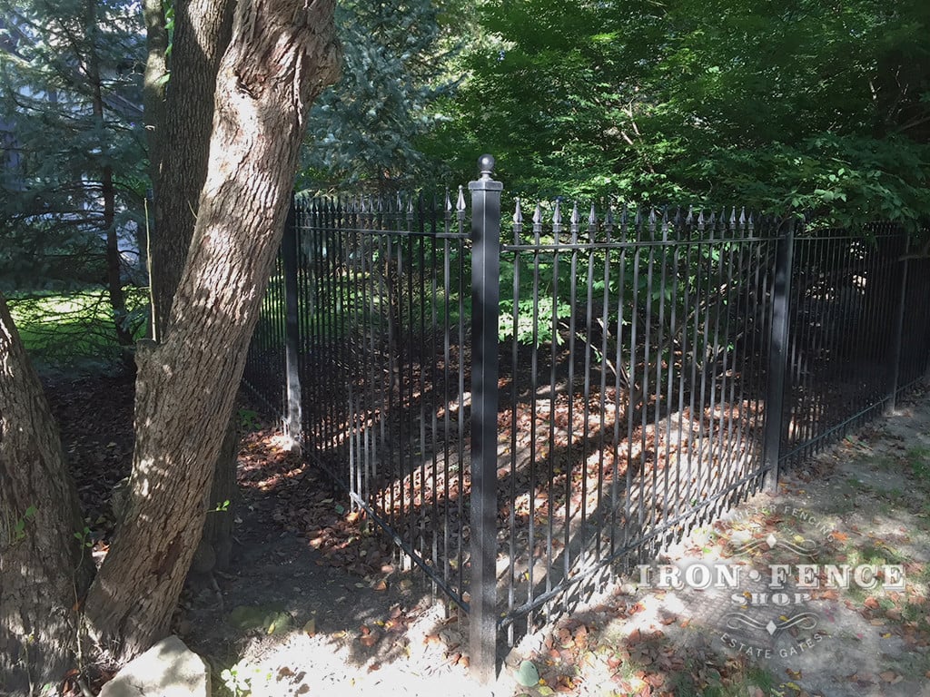 5ft Tall Classic Style Wrought Iron Fence Installed Around a Wooded Lot